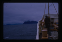 Image of People on deck, foggy mountain in distance