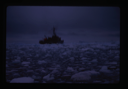 Image of Naval ship moving through drift ice.