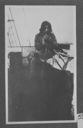 Image of Eskimo with pipe on deck