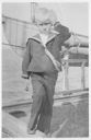 Image of Robert Peary, Jr. saluting on deck of SS Roosevelt