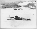 Image of Koo-e-tig-e-to [Kuutsiikitsoq] on the ice behind sealing screen, June 24, 1924