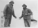 Image of [Man and MacMillan holding tiny fish]