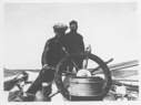 Image of [Two men at wheel.] One is Ralph Robinson
