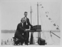 Image of [F.H. Schnell (l) and K. B. Warner (r) of ARRL  testing Wireless North Pole radio  (on the Bowdoin), on dock at Wiscasset next to the Bowdoin]