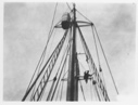Image of E.F. McDonald at masthead of BOWDOIN to set Chicago Yacht Club pennant