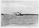 Image of [Ship with flags, billowing smoke]