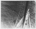Image of [Man climbing rigging as seen from above]
