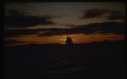 Image of Fishing schooner against sunset sky.