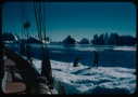 Image of Icebergs through rigging; MM and Pete on ice pan getting water