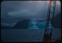 Image of Iceberg through rigging; stormy sky