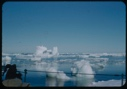 Image of Icebergs and scattered ice beyond rail