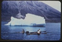 Image of Three kayakers near iceberg