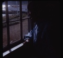Image of Eskimo [Inuk] man looking out window