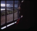 Image of Eskimo [Inuk] woman looking out window