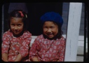 Image of Two Eskimo [Inuit] girls sitting on steps