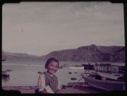 Image of Eskimo [Inuk] girl sitting on boardwalk at beach