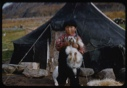 Image of Eskimo [Inuk] boy holding pup