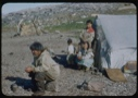 Image of Eskimo [Inuit] family by sealskin tent