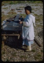 Image of Eskimo [Inuk] woman drying sinew