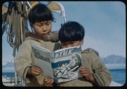 Image of Two Eskimo [Inuit] boys on the BOWDOIN look at ”Etuk”