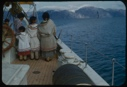 Image of Eskimo [Inuit] woman and children by the wheel