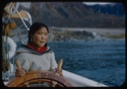 Image of Eskimo [Inuk] girl at wheel