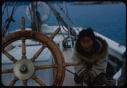 Image of Elderly Eskimo [Inuk] woman near wheel