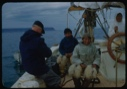 Image of Donald MacMillan, Harrigan [Inukitooq], Ootaq with another Eskimo [Inuk] man at wheel