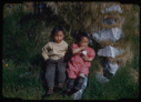 Image of Two children by sod-stone house