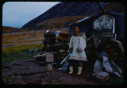 Image of Eskimo [Inuk] grandmother outside her home