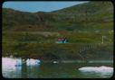Image of Frame building near water. Dying icebergs