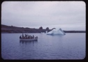 Image of Eskimos [Inuit] in open boat waving goodbye