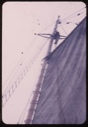 Image of Crewman in rigging, sail up