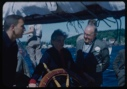 Image of Miriam MacMillan at wheel with crew and guests