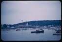 Image of The Bowdoin at departure surrounded by small boats for escort