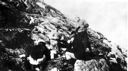 Image of 3 crew men and 2 Inuit on rocks
