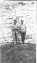 Image of Two men (crew?) against stone wall