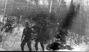 Image of [Donald MacMillan (in short sleeves) and ? in snowy woods]
